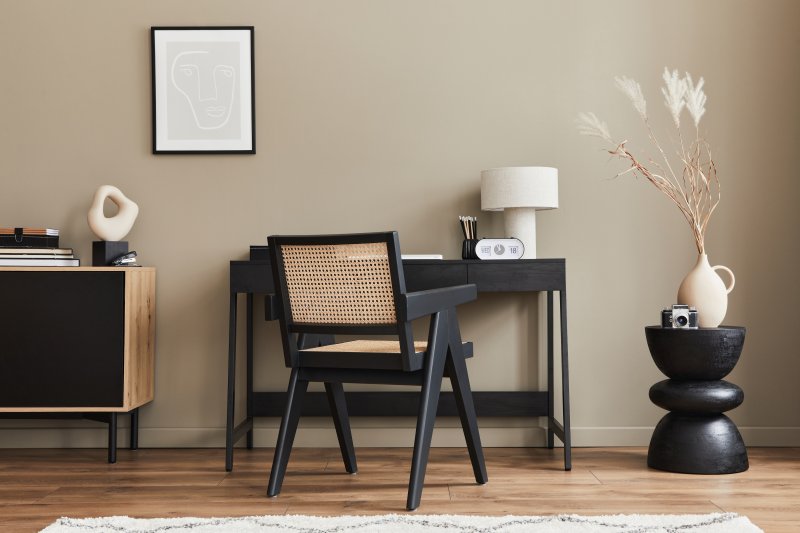 Neutral modern home office with black wooden furniture, wood floor, white rug and white decor elements (Photo by FollowTheFlow - stock.adobe.com)